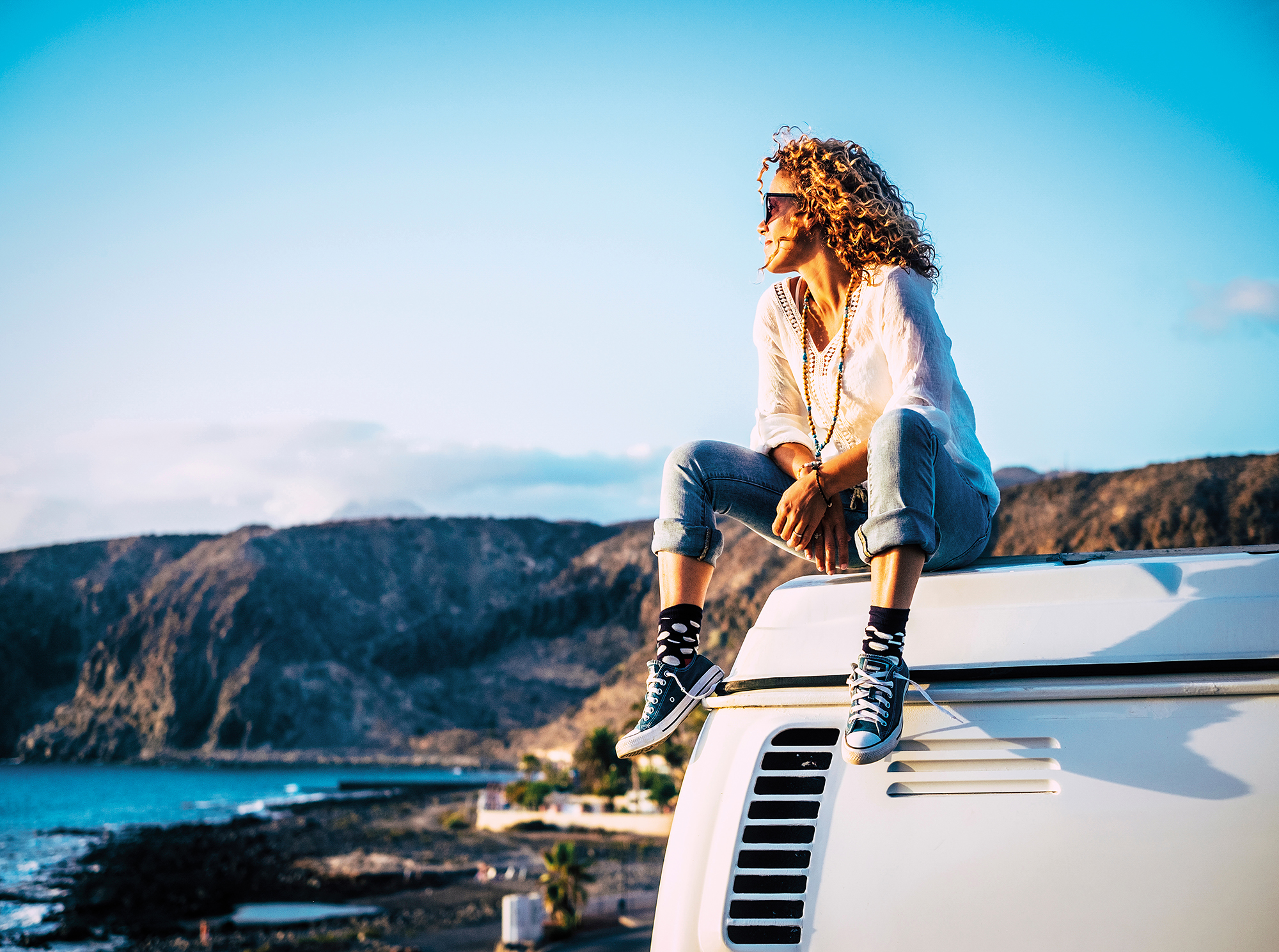 woman sitting on top camper van